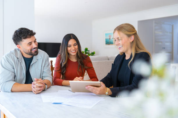 Life insurance consultant reviewing policy options with a couple in Australia